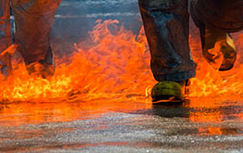 Image of legs (below the knee) running through a surface fuel (e.g. jet fuel) fire